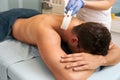 Young man receiving laser epilation on beauty center Royalty Free Stock Photo