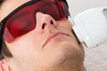 Man receiving laser hair removal treatment Royalty Free Stock Photo