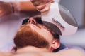 Young Man Receiving Laser Hair Removal Treatment At Beauty Center. Royalty Free Stock Photo