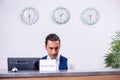 Young man receptionist at the hotel counter Royalty Free Stock Photo