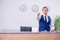 Young man receptionist at the hotel counter Royalty Free Stock Photo