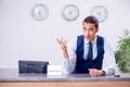 Young man receptionist at the hotel counter Royalty Free Stock Photo