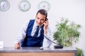 Young man receptionist at the hotel counter Royalty Free Stock Photo