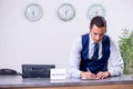 Young man receptionist at the hotel counter Royalty Free Stock Photo