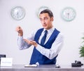 Young man receptionist at the hotel counter Royalty Free Stock Photo