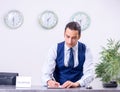 Young man receptionist at the hotel counter Royalty Free Stock Photo