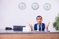 Young man receptionist at the hotel counter Royalty Free Stock Photo