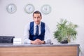 Young man receptionist at the hotel counter Royalty Free Stock Photo