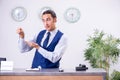 Young man receptionist at the hotel counter Royalty Free Stock Photo