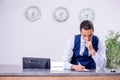 Young man receptionist at the hotel counter Royalty Free Stock Photo