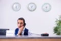 Young man receptionist at the hotel counter Royalty Free Stock Photo