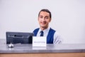 Young man receptionist at the hotel counter Royalty Free Stock Photo