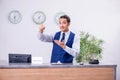 Young man receptionist at the hotel counter Royalty Free Stock Photo