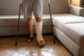 Young man recovering after accident at home with crutches Royalty Free Stock Photo