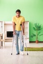 The young man recovering after accident at home with crutches Royalty Free Stock Photo