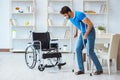 Young man recovering after surgery at home with crutches and a w Royalty Free Stock Photo