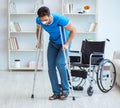 Young man recovering after surgery at home with crutches and a w Royalty Free Stock Photo