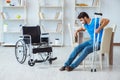 Young man recovering after surgery at home with crutches and a w Royalty Free Stock Photo