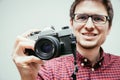 Young man is taking a picture with a vintage camera Royalty Free Stock Photo