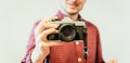 Young man is taking a picture with a vintage camera Royalty Free Stock Photo