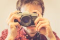 Young man is taking a picture with a vintage camera Royalty Free Stock Photo