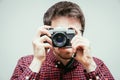 Young man is taking a picture with a vintage camera Royalty Free Stock Photo