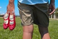 Young man with red flamenco shoes in his hand Royalty Free Stock Photo