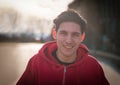 Young man in red hoodie smiles at camera Royalty Free Stock Photo