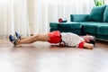 A young man in red shorts is doing exercises on a foam roller, works out of the muscles with a massage roller. Athletic
