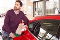 Young man refuelling a car at a petrol station Royalty Free Stock Photo