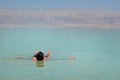 The young man relaxes and swims in the water of the Dead Sea in Israel. tourism, health improvement, recreation, healthy lifestyle Royalty Free Stock Photo