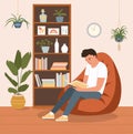 Young man is relaxing on comfortable beanbag chair and reading book. Vector flat cartoon illustration