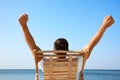 Young man relaxing in deck chair on beach Royalty Free Stock Photo