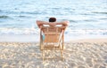 Young man relaxing in deck chair on beach Royalty Free Stock Photo