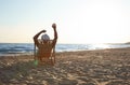 Young man relaxing in deck chair on beach  sea Royalty Free Stock Photo