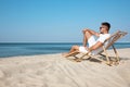 Young man relaxing in deck chair Royalty Free Stock Photo