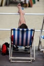 Young Man Relaxing in Deckchair on Beach Royalty Free Stock Photo