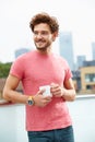 Young Man Relaxing On Roof Terrace With Cup Of Coffee Royalty Free Stock Photo