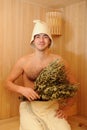 Young man relaxing in a russian wooden sauna