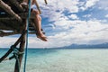 Young man relaxing and sitting on edge of sea beach pier in summer beach scenery. Royalty Free Stock Photo