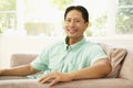 Young Man Relaxing On Sofa At Home Royalty Free Stock Photo