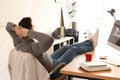 Young man relaxing at table in office Royalty Free Stock Photo