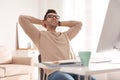 Young man relaxing at table in office Royalty Free Stock Photo