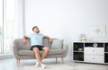 Young man relaxing under air conditioner