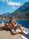Young man relaxing on a wooden boat during a boat trip to Butterfly beach at Fethiye Turkey, Tanning young boy in swim Royalty Free Stock Photo