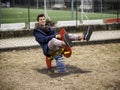 Young man reliving his childhood in a playground