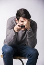 Young man with remote control, covering his eyes scared Royalty Free Stock Photo