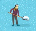 Young man removing snow with a shovel.