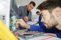 Young man repairer working in service center