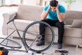 The young man repairing bicycle at home